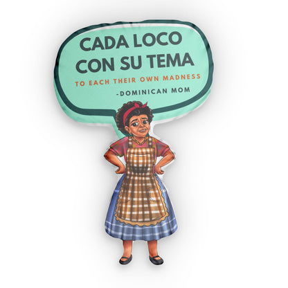 Throw pillow shaped like a Dominican mom in a checkered apron with a speech bubble saying "Cada Loco Con Su Tema".